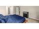 This bedroom has neutral walls and carpet, with blue bedding and modern black dresser at 2606 S Durango Dr # 245, Las Vegas, NV 89117