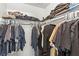 Walk-in closet with organized hanging clothes on both sides and upper shelves at 2606 S Durango Dr # 245, Las Vegas, NV 89117