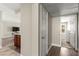 Hallway with dark wood floors leading to a living area and additional rooms, highlighting open layout at 2606 S Durango Dr # 245, Las Vegas, NV 89117