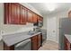 Well-lit kitchen featuring stainless steel appliances and dark wood cabinets at 2606 S Durango Dr # 245, Las Vegas, NV 89117