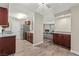 Open kitchen view with granite countertops and fireplace in the living room at 2606 S Durango Dr # 245, Las Vegas, NV 89117