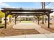 Common area shows a pergola with paver patio, seating, and nearby putting green at 2606 S Durango Dr # 245, Las Vegas, NV 89117