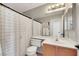 Bathroom featuring a shower with curtain, single sink vanity, and a large mirror at 2684 Korea Ct, Henderson, NV 89052