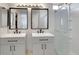 Bathroom featuring double sinks, dark hardware, and a glass-enclosed shower at 2684 Korea Ct, Henderson, NV 89052
