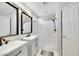 Bright bathroom featuring double sinks and a shower with white subway tile at 2684 Korea Ct, Henderson, NV 89052