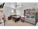 Bedroom with neutral carpet, ceiling fan, and a window providing natural light at 2684 Korea Ct, Henderson, NV 89052