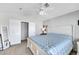 Bedroom featuring a white wooden bed frame, ceiling fan, closet, and a full-length mirror at 2684 Korea Ct, Henderson, NV 89052