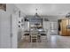 Stylish dining room with a farmhouse table, modern lighting, and ample storage cabinets at 2684 Korea Ct, Henderson, NV 89052