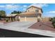 Charming two-story home boasts a spacious three-car garage and a well-maintained front yard with rock landscaping at 2684 Korea Ct, Henderson, NV 89052
