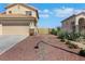 A well-maintained home with rock landscaping, showing the entrance to the back yard at 2684 Korea Ct, Henderson, NV 89052