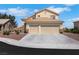Charming two-story home boasts a spacious three-car garage and a well-maintained front yard with rock landscaping at 2684 Korea Ct, Henderson, NV 89052