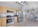Modern kitchen showcasing stainless steel appliances and open layout connecting to the dining area at 2684 Korea Ct, Henderson, NV 89052