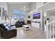 Cozy living room featuring a fireplace, neutral walls, high ceilings, tile floors, and modern furniture at 2684 Korea Ct, Henderson, NV 89052
