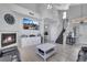 Cozy living room showcasing a fireplace, large TV, neutral decor, and staircase access at 2684 Korea Ct, Henderson, NV 89052