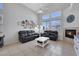 Bright, open living room with high ceilings, a fireplace, tile floors, modern furniture, and ample natural light at 2684 Korea Ct, Henderson, NV 89052