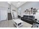 Bright living room featuring high ceilings, tile floors, and a comfortable gray leather sofa at 2684 Korea Ct, Henderson, NV 89052