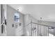 Well-lit staircase with white railing and neutral walls decorated with Gathering photos at 2684 Korea Ct, Henderson, NV 89052