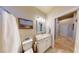 Bathroom features a tiled floor, and a vanity with sink near the toilet and shower-tub at 2713 Tanagrine Dr, North Las Vegas, NV 89084