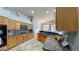 Bright kitchen featuring granite countertops, stainless steel appliances, and ample cabinet space at 2713 Tanagrine Dr, North Las Vegas, NV 89084