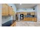 Well-equipped kitchen boasting stainless steel refrigerator, oven and microwave with beautiful tile floors at 2713 Tanagrine Dr, North Las Vegas, NV 89084