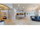 Open-concept living space with tile flooring, kitchen with breakfast bar, and comfortable seating at 2713 Tanagrine Dr, North Las Vegas, NV 89084