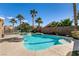 Inviting backyard pool featuring mature palm trees and stone accents at 2713 Tanagrine Dr, North Las Vegas, NV 89084