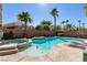 Inviting backyard pool and spa surrounded by lush palm trees under a clear blue sky at 2713 Tanagrine Dr, North Las Vegas, NV 89084