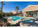 Stunning backyard with a sparkling pool, spa, and outdoor seating area for relaxation at 2713 Tanagrine Dr, North Las Vegas, NV 89084
