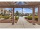 View of the community pool and clubhouse from a covered walkway with lush landscaping at 2900 Sunridge Heights Pkwy # 1916, Henderson, NV 89052