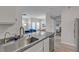 Bright kitchen with stainless steel sink, granite countertops, and open view to the living and dining areas at 2900 Sunridge Heights Pkwy # 1916, Henderson, NV 89052