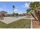 Community swimming pool surrounded by lounging chairs and palm trees under a partly cloudy sky at 2900 Sunridge Heights Pkwy # 1916, Henderson, NV 89052
