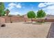 Spacious backyard features gravel landscaping, mature trees, and a cozy lounge area, creating a versatile outdoor space at 3102 Honeysuckle Ave, North Las Vegas, NV 89031