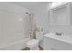 Bright bathroom with a shower-tub combo, white tile, and modern fixtures, offering a clean and functional space at 3102 Honeysuckle Ave, North Las Vegas, NV 89031