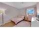 Charming bedroom with a twin-sized bed, pink accents, and plenty of natural light, perfect for a cozy retreat at 3102 Honeysuckle Ave, North Las Vegas, NV 89031