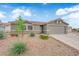 Charming single-story home with a desert rock landscape and a spacious two-car garage at 3102 Honeysuckle Ave, North Las Vegas, NV 89031