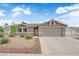 Charming single-story home featuring a low-maintenance desert landscape and a two-car garage at 3102 Honeysuckle Ave, North Las Vegas, NV 89031
