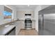 A kitchen features an oven, stainless steel refrigerator, sink, and window at 3102 Honeysuckle Ave, North Las Vegas, NV 89031
