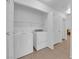 A laundry room features a washer, a dryer, and shelving at 3102 Honeysuckle Ave, North Las Vegas, NV 89031