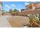 A spacious backyard with desert landscaping and a patio area, surrounded by a brick privacy wall, ready to customize at 3273 Alcudia Bay Ave, Las Vegas, NV 89141