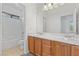 Bathroom features dual sinks, wooden cabinets, tile flooring, and a shower/tub combo at 3273 Alcudia Bay Ave, Las Vegas, NV 89141
