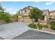Lovely two-story home featuring a spacious driveway, mature trees, and a charming facade at 3273 Alcudia Bay Ave, Las Vegas, NV 89141
