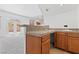 Granite counters and wood cabinetry highlight this space that overlooks the living room at 3273 Alcudia Bay Ave, Las Vegas, NV 89141