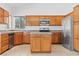 Spacious kitchen showcasing an island, stainless steel appliances, and ample cabinet space for storage at 3273 Alcudia Bay Ave, Las Vegas, NV 89141