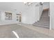 Bright living room boasts tile flooring, carpet, and a staircase leading to the upper level at 3273 Alcudia Bay Ave, Las Vegas, NV 89141