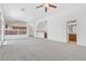 Open-concept living room featuring plush carpeting and a seamless flow to the kitchen at 3273 Alcudia Bay Ave, Las Vegas, NV 89141