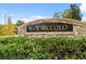 A welcoming entrance to the San Niccolo community, framed by lush greenery and a stone monument, creating a sense of arrival at 3273 Alcudia Bay Ave, Las Vegas, NV 89141