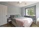 Cozy bedroom with natural light and a built-in desk area, features neutral walls and wood-look floors at 3728 Juanita May Ave, North Las Vegas, NV 89032