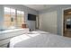Bedroom featuring a large window and a dresser with built-in storage, neutral walls and wood-look floors at 3728 Juanita May Ave, North Las Vegas, NV 89032