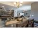 Open-concept dining area with seating for six flowing into a cozy living space at 3728 Juanita May Ave, North Las Vegas, NV 89032