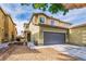 Two-story home showcasing a two-car garage and neutral color scheme with well-kept landscaping at 3728 Juanita May Ave, North Las Vegas, NV 89032